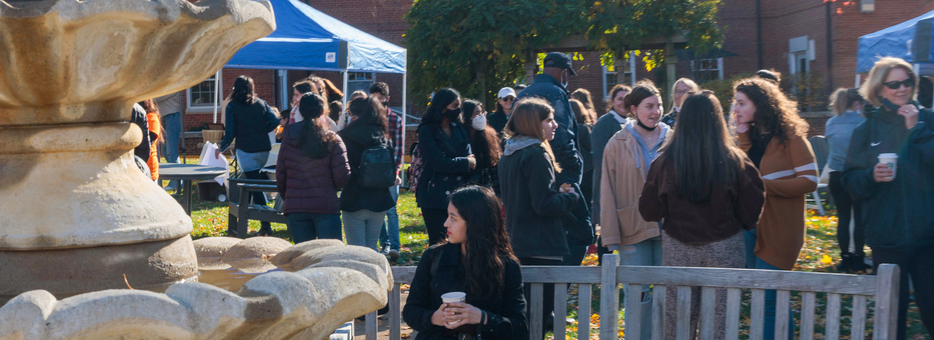 the GW community gathers on campus by a fountain